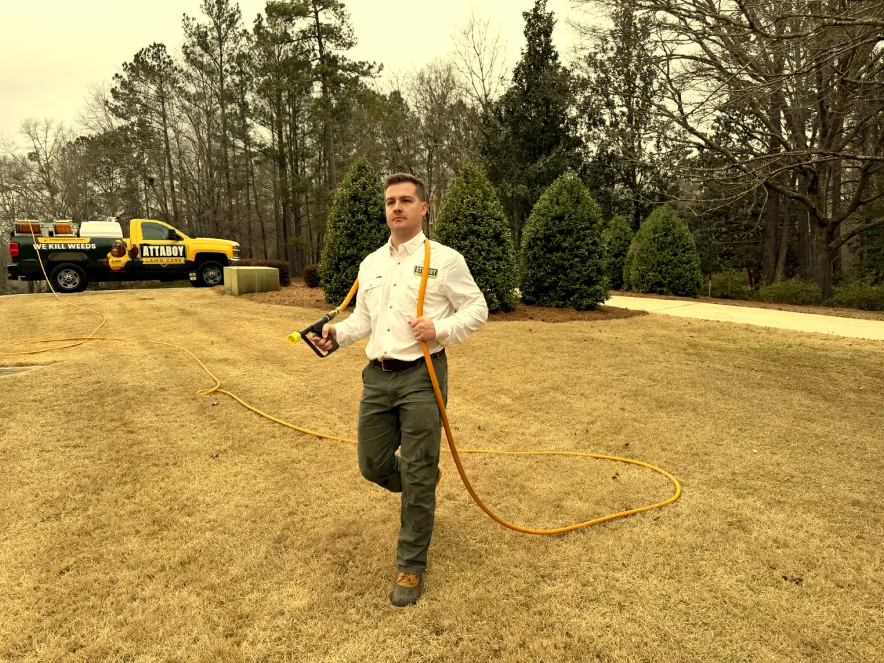 Attaboy Lawn Care professional with spray equipment for lawn disease treatment