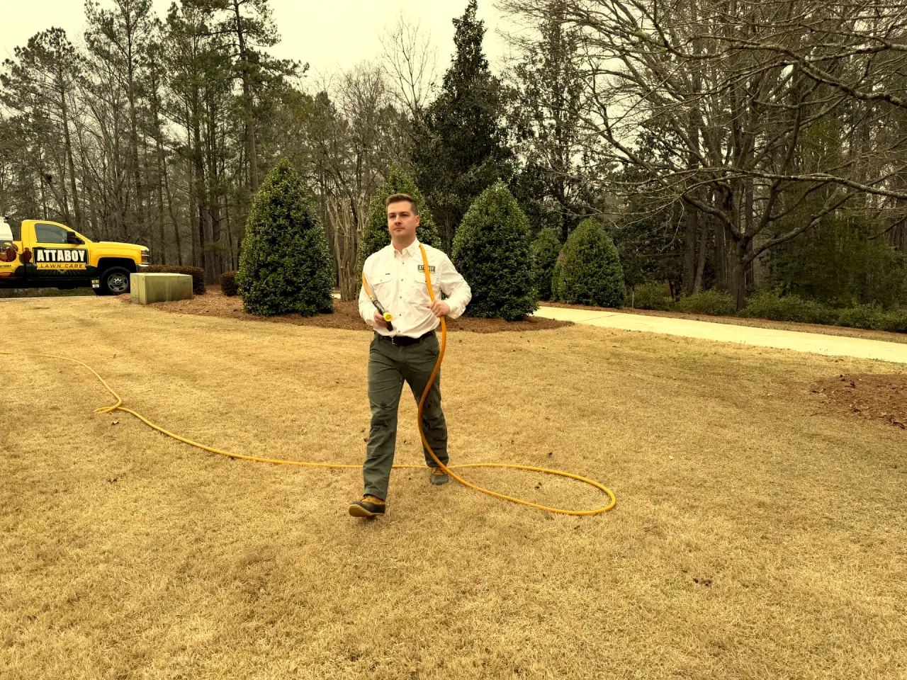 Attaboy Lawn Care owner ready to apply soil conditioning treatment